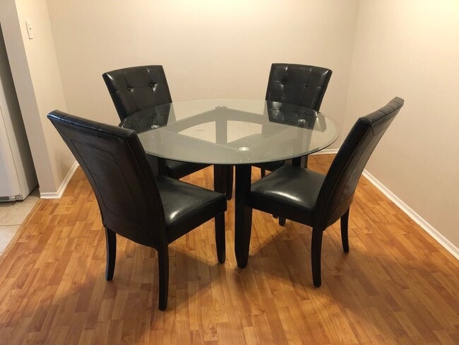 Dining space with glass table and leather chairs - 8315 Karam Blvd Unit 8315