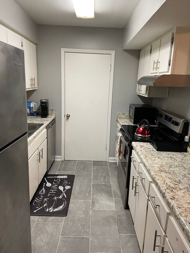 Kitchen with door leading to pantry/ laundry room - 6005 Wingate Way Unit Fully Furnished 1BD 1BR