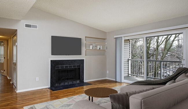 Spacious central living room with wood plank flooring - Burke Shire Commons Apartments