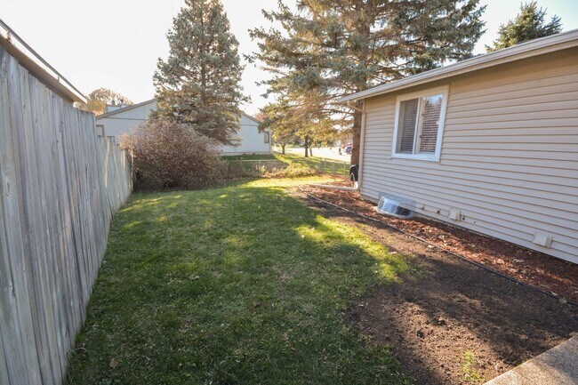 Photo - Ranch-style home with great fenced yard & patio!