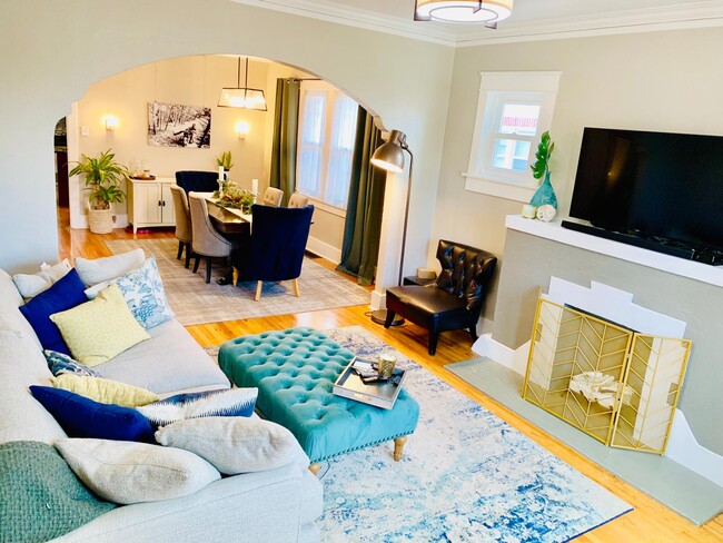 Upstairs living room with large windows, real hardwood floors, decorative fireplace, and full of cra - 1447 Osceola St House