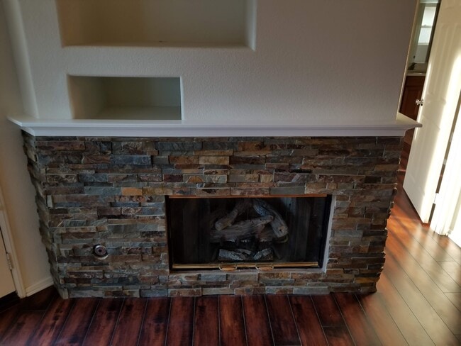 Stacked stone fireplace with gas fireplace insert - 16939 Robins Nest Way Unit 1