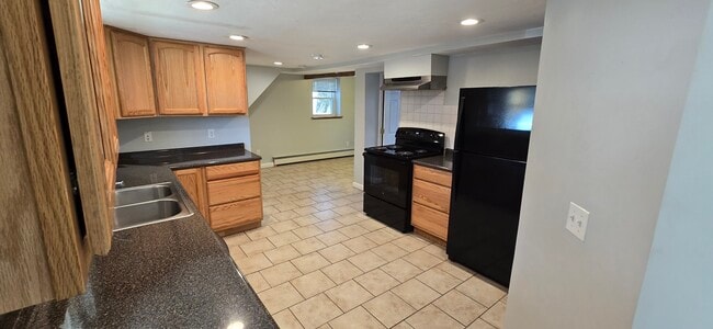 Kitchen looking toward dining nook and Bedroom 2 - 103 S Main St Unit Basement