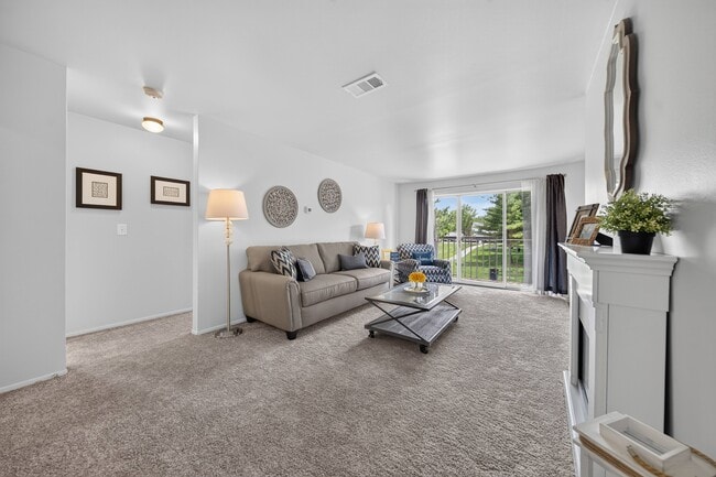 Elevated living room and private balcony at Drawbridge Apartments. - Drawbridge Apartments East