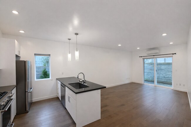 Spacious living room with dual-zone AC and abundant natural light and with access to private patio - 1733 NW 63rd St