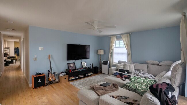 Super sunny extra large living room with ceiling fan