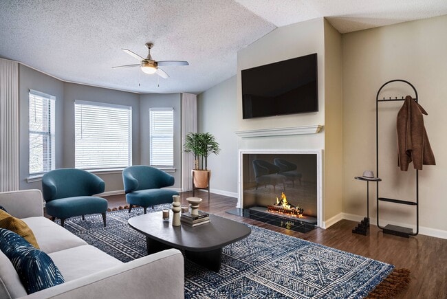 Living area's large windows and fireplace - Avana Bellevue Apartments