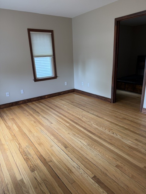 Main level living room with original hardwood floors and large windows and main bedroom located - 4238 State Park Dr
