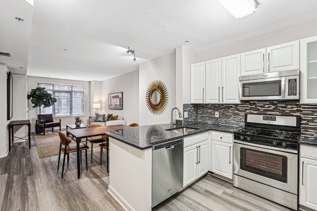 View from Kitchen Toward Bedroom, Dining Table, and Windowed Living Room - The Barton at Woodley Rental