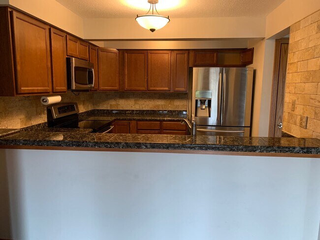 Kitchen from dining area - 8150 Shorewalk Dr Unit B