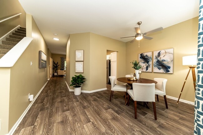 Dining area with hardwood-style flooring and overhead lighting