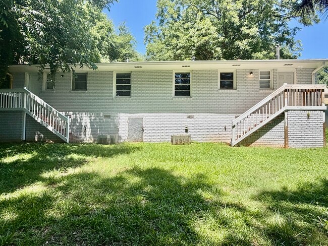 Rear Exterior- large backyard with elevated deck access. - 125 Trio Ln Unit A