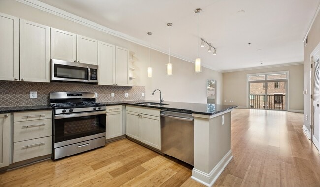 Stainless steel appliances and granite countertops in designer kitchen