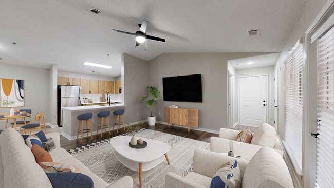 Open floorplan kitchen/living room with modern hardwood style flooring. - Preston Hills at Mill Creek Apartments