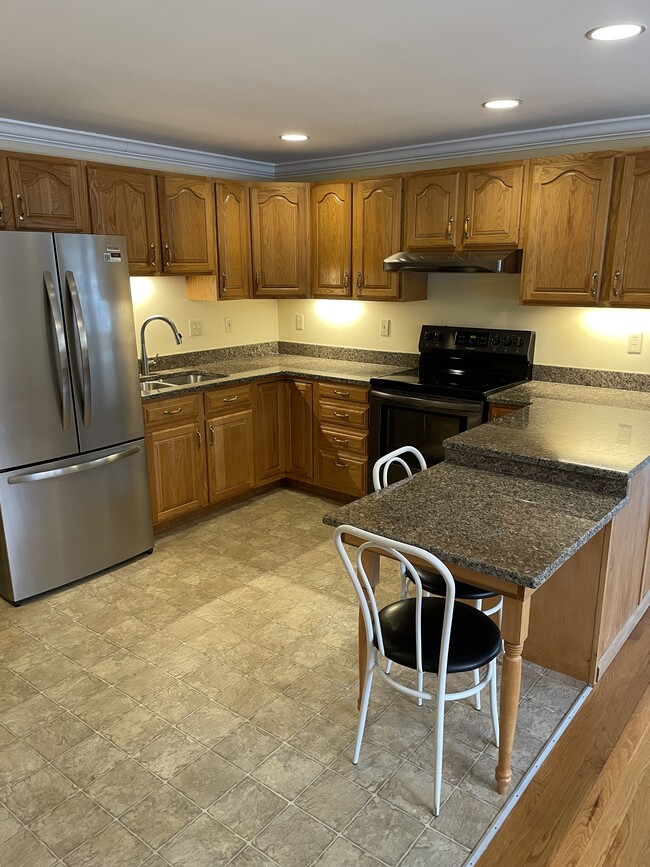 Kitchen with stainless steel appliances and granite countertops - 123 Riverlin St Unit 123A
