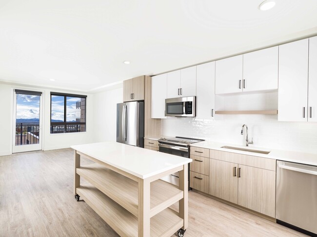 Creating culinary magic with a chef's dream island complete with ample storage, found in the heart of Modera Golden Triangle, Denver, Colorado. - Modera Golden Triangle Apartments