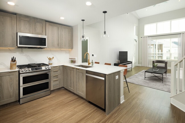 Signature Collection kitchen and living room with hard surface flooring