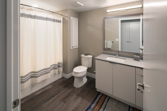 Bath with quartz countertop and hard surface flooring