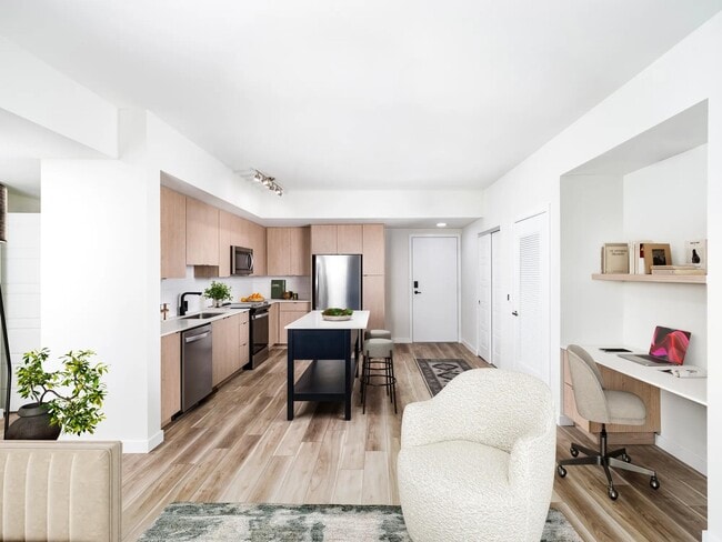 Open-concept kitchens at Modera Aventura pair sleek finishes with the convenience of an in-home office space. - Modera Aventura