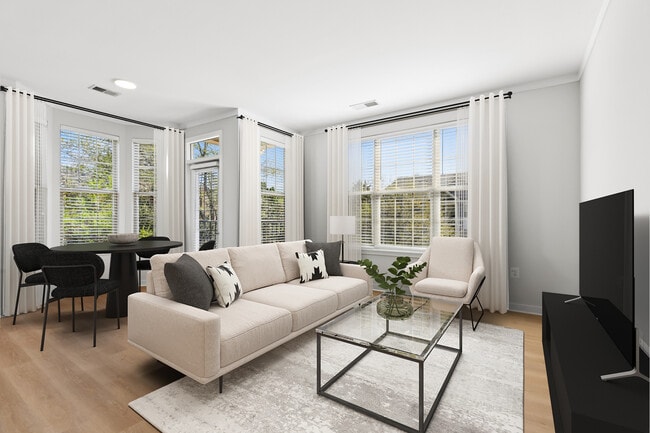 Renovated Package II dining and living room with hard surface flooring - Avalon Falls Church