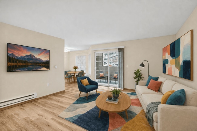 Spacious open living and dining area with direct access to a private covered patio. - Tudor Village at the Mall Apartments