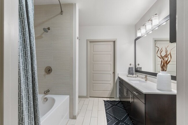 Modern bathroom features include upgraded lighting, fixtures and framed mirrors