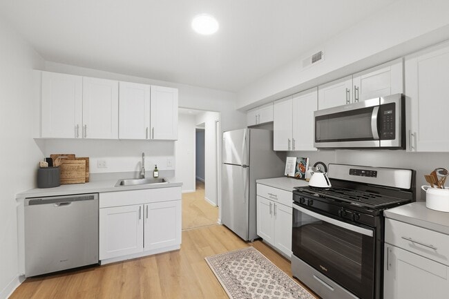 Elevate your lifestyle at Fairway Apartments with this sleek modern kitchen featuring stainless steel appliances, ample storage, and inviting design. Your culinary haven awaits. Schedule your tour today!
