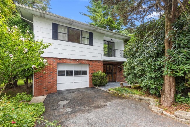 View of front of property with a garage and a balcony. - 45 High St House