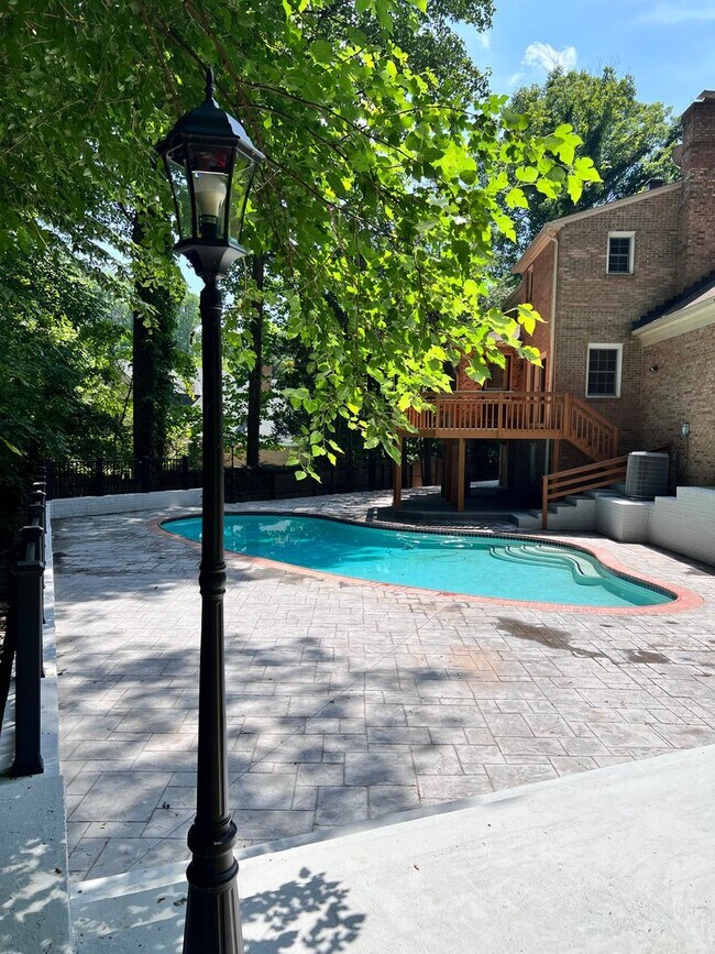 Photo - 5 BR 4.5 BA home with inground heated pool and extensive hardscape!