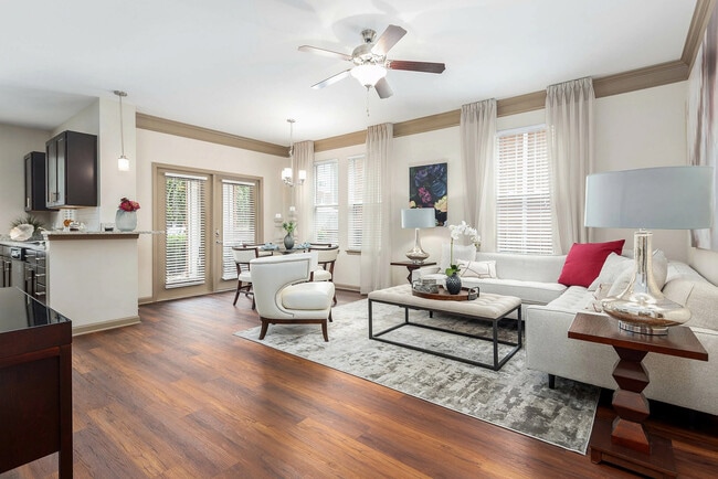 Spacious open-concept living and dining area with hardwood-style flooring, abundant natural light, and elegant finishes—luxury apartment living in Charlotte.