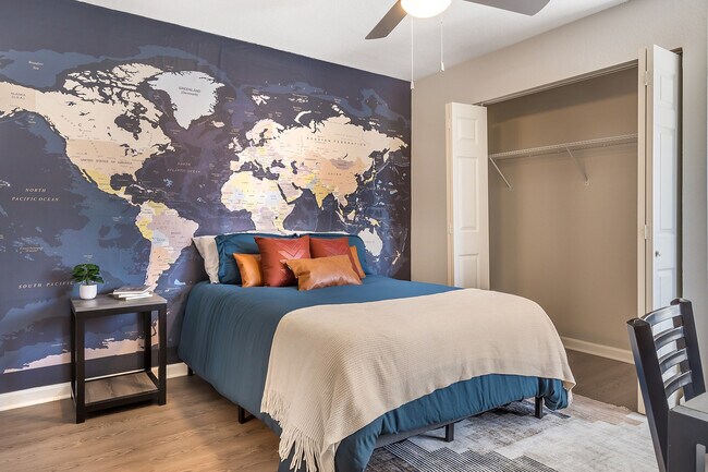 Explore your dreams in this vibrant bedroom with a world map accent and inviting decor.