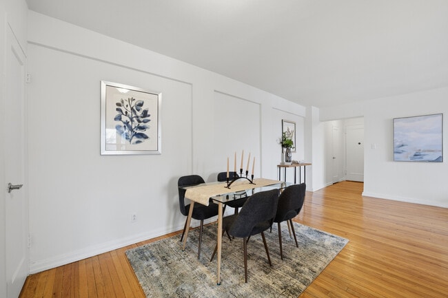 Dining area featuring hardwood floors with convenient access to the kitchen. - 555 Broadway Unit 4F