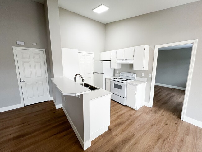 Large kitchen with peninsula and bar seating area. - 6521 W Lucky Ln Unit 201