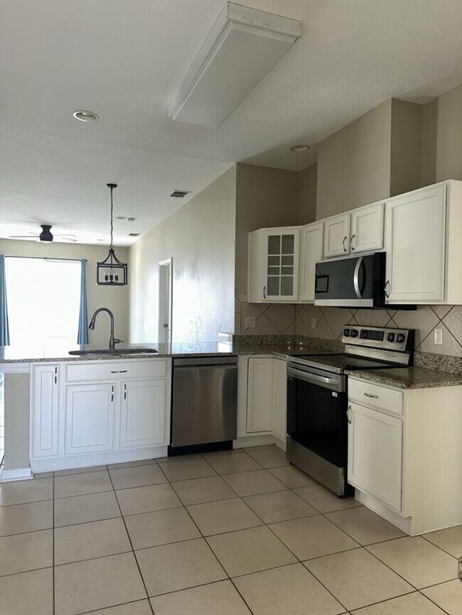 Photo - PALM COVE - 4/3 WITH ADDITIONAL DEN AND UPSTAIRS LOFT