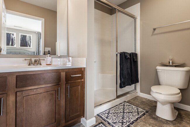 Step into a stylish bathroom at Wheaton Village, featuring a walk-in shower and a clean, inviting design for everyday comfort.
