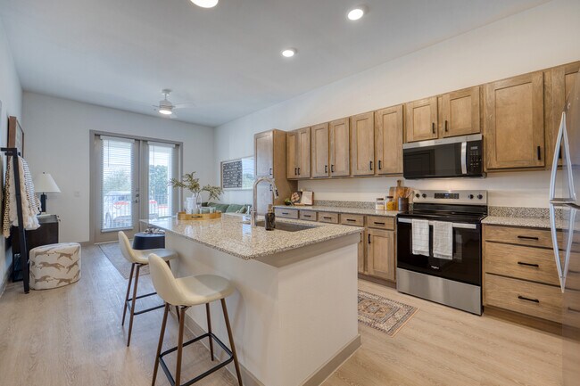Modern kitchen with a spacious island and open layout at Residence at Pearsall Park