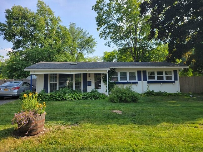 Front of house with solar roof, flowers - 20 Princeton St