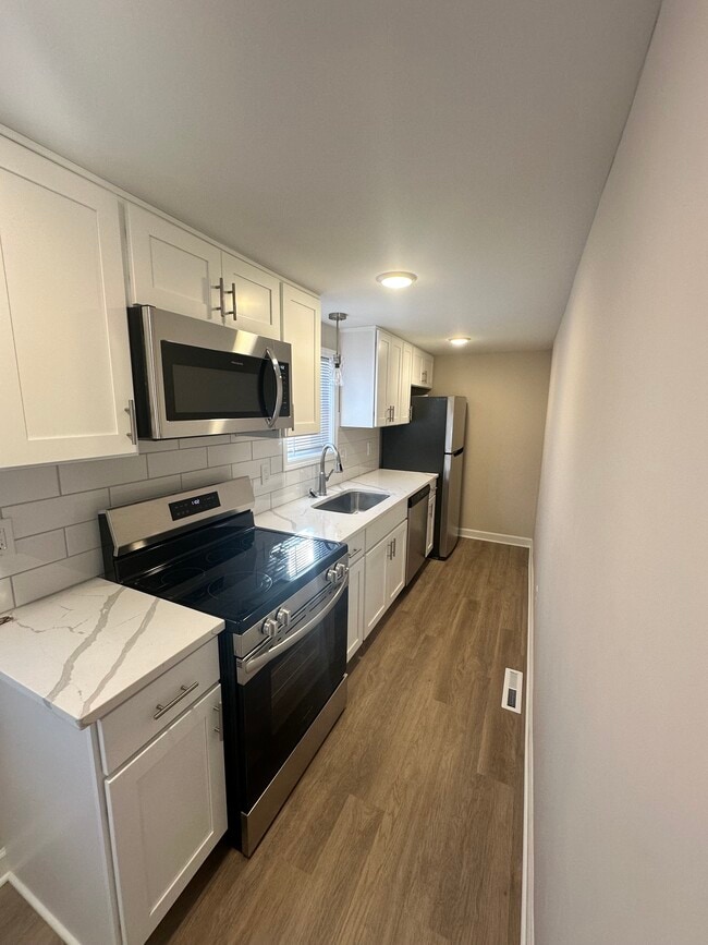 Kitchen w/ Quartz Countertops and Frigidaire Stainless Steel Appliances - 437 Franklin St