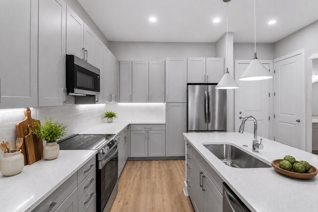 Quartz countertops, stainless steel appliances, and effortless style — this kitchen sets the tone for boundless living.