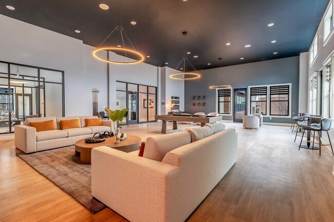 Experience luxury living in this elegantly designed lounge, perfect for relaxation and entertainment. - Colony Lofts
