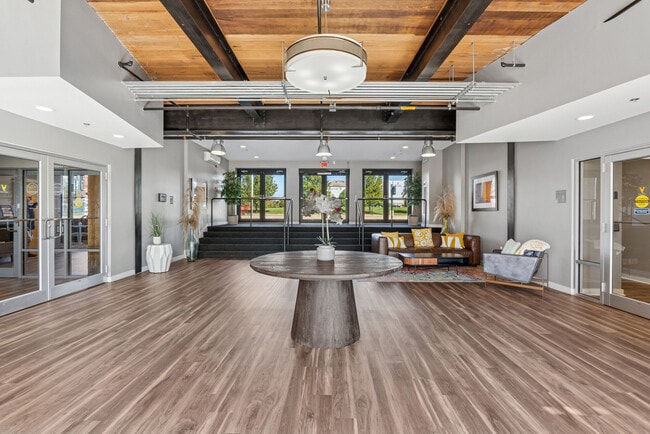 Resident clubhouse lounge with coworking spaces, social seating, and premium amenities