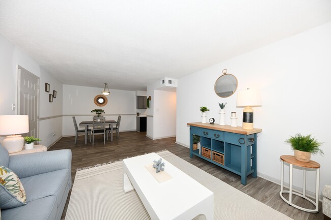 Living Room with Hardwood Style Flooring - The Abigail Apartments