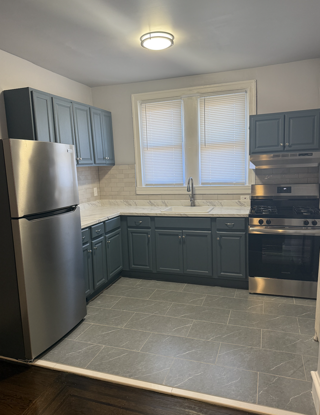 kitchen with stainless steal appliances - 6305 Kingsessing Ave Casa