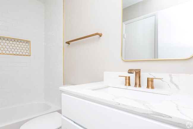 Upgraded Renovation with stunning tile detail, gold fixtures, custom shower niches and marble style quartz countertops