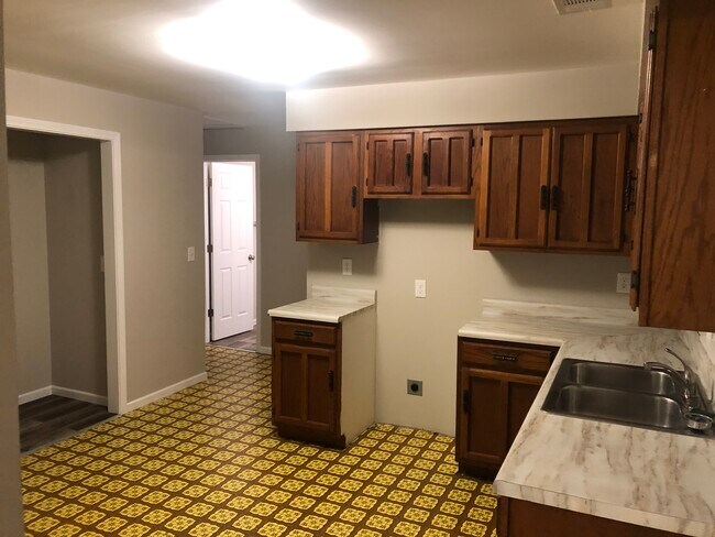 Kitchen includes stainless steel stove and refrigerator - 304 NE 8th St Unit 304 NE 8th St.
