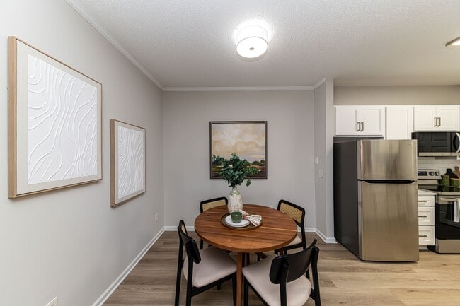 Dining area with hardwood-style flooring and overhead lighting