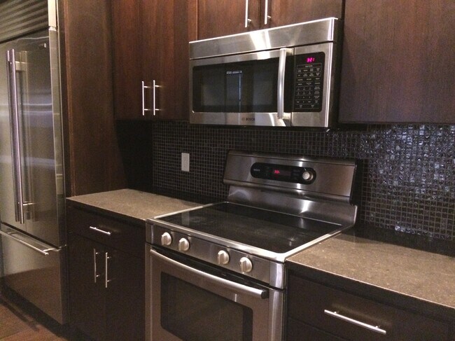 At the Frank, all the kitchens have the tile back splash & stone counters.