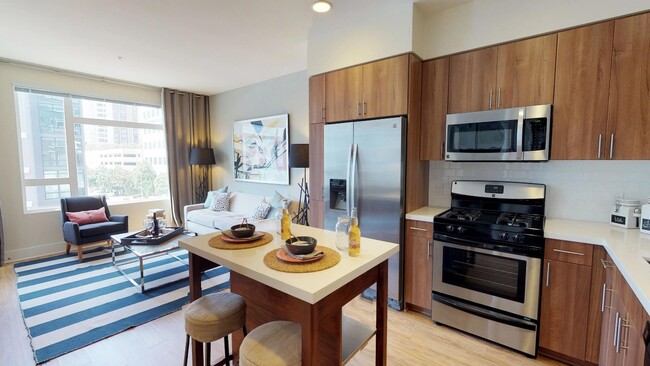 Upscale kitchen featuring gas cook top and french door refridgerator - Modera Glendale Apartments