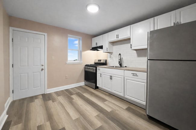 Photo - Renovated 3BR Rowhome with Central AC & Fenced Yard
