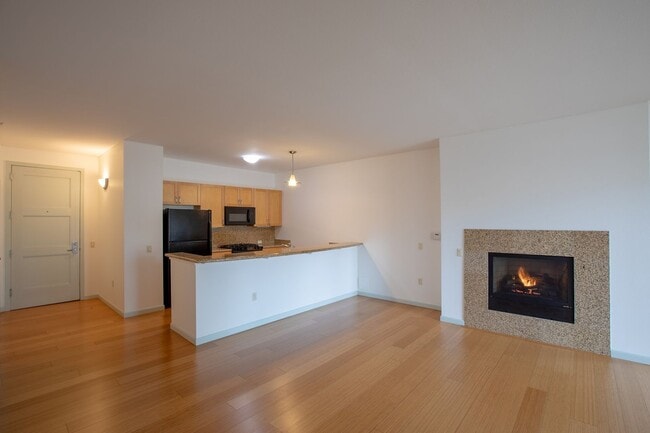 Building Photo - Sweet + secure 1/1 condo with parking, extra storage room + AC available now! Unit 206